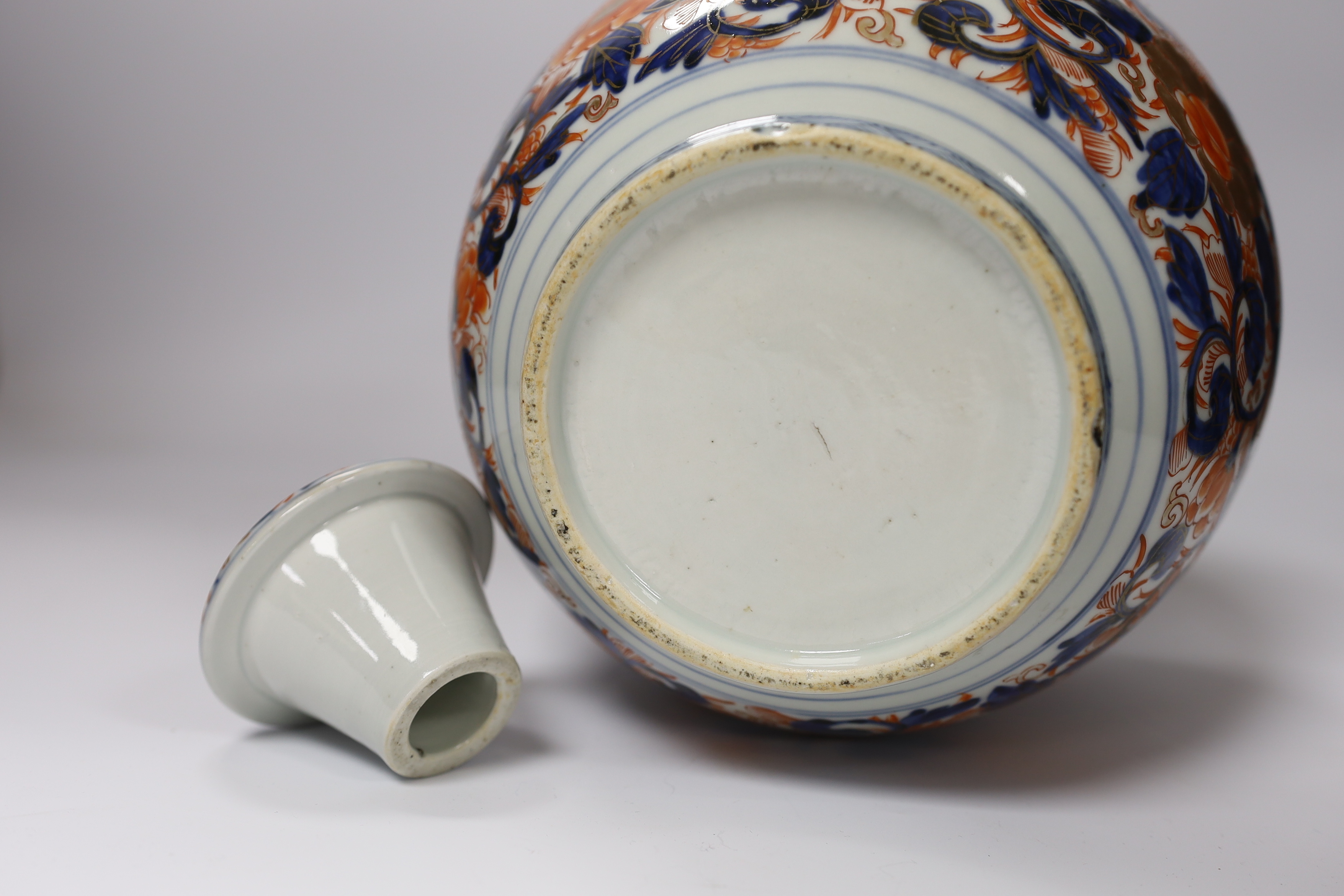 A pair of Chinese blue and white crackleware vases and covers and an Imari vase and cover, largest 31cm high